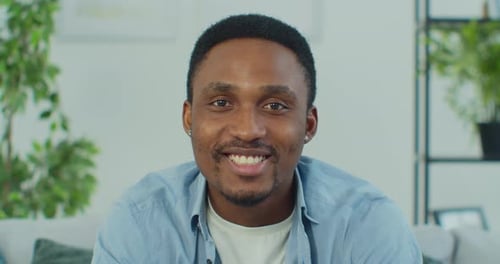 Man Smiling and Speaking Directly to Camera