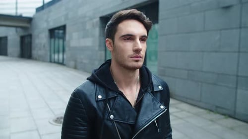 Portrait of Hipster Man Walking Street in Slow Motion. Focused Man Walking City