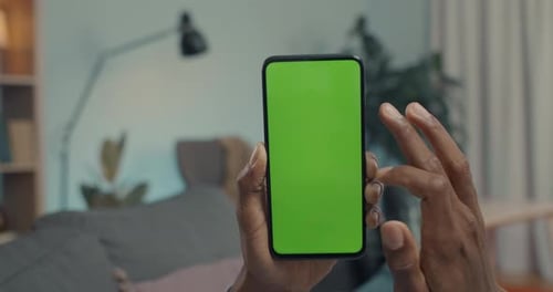 Close Up of African American Man Using Smartphone with Green Screen