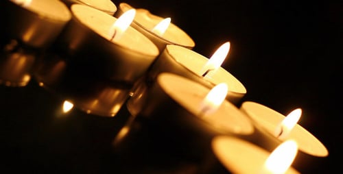 Close Up of Candles Burning in Darkness