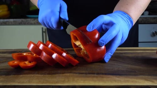 Red Bell Pepper Sliced into Rings with Knife