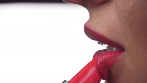Adult Applies Red Lipstick in Extreme Close-Up