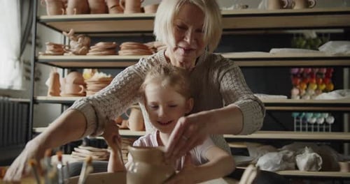Grandmother and Child Making Pottery Together