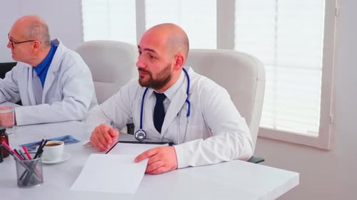Doctor Talking About Healthcare During Seminar with Hospital Staff