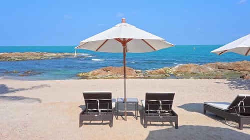 Tropical Holiday Concept, Sunbeds and Parasols on Beach With Horizon View