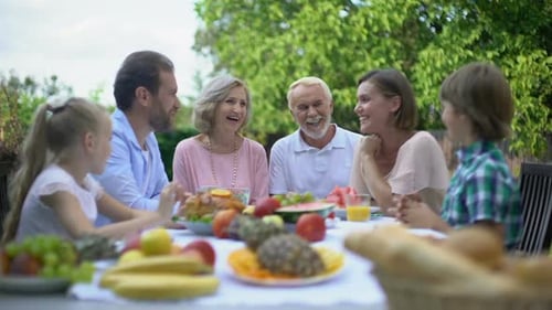Happy Family Enjoying Outdoor Meal Together