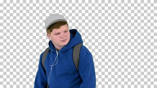Handsome school boy walking by while listening, Alpha Channel