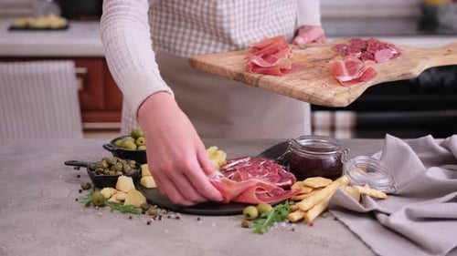 Arranging Charcuterie Plate With Prosciutto and Cheese
