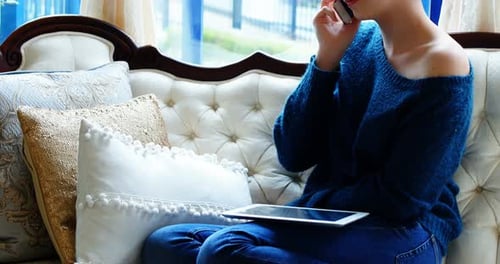 Woman Talking on Phone Indoors on Fancy Couch
