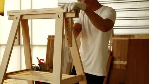 Woodwork and furniture making concept. Stylish craftsman working in his carpentry workshop