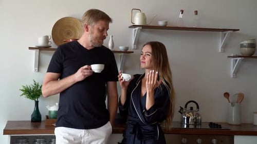 Couple Chatting Over Tea in Bright Kitchen