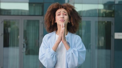 Woman Celebrating Success Outside Modern Office Building