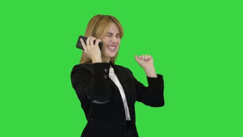 Happy Business Woman Enjoy Success on Mobile Phone on a Green Screen, Chroma Key.