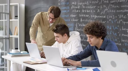 Students Learning Code in Classroom with Teacher