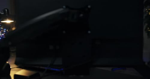 Man Coding at Computer in Dark Home Office