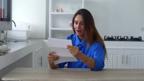 Woman Reading Letter Receives Good News and Celebrates