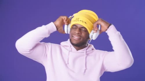 Happy Surprised Hipster Man Listening Music with Headphones at Music Studio.