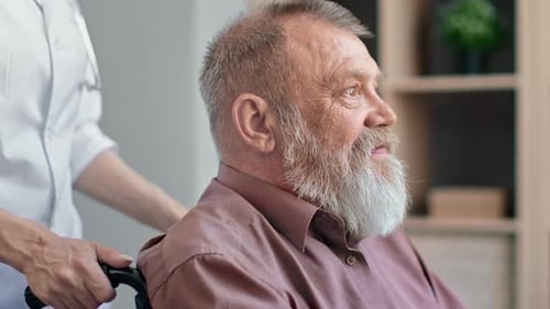 Closeup Smiling Disabled Grandfather Riding on Wheelchair to Physical Treatment at Hospital