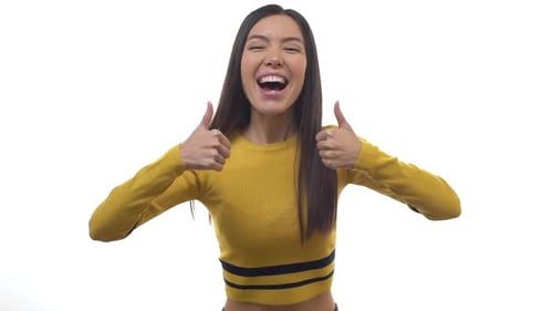 Enthusiastic Young Woman Giving Two Thumbs Up