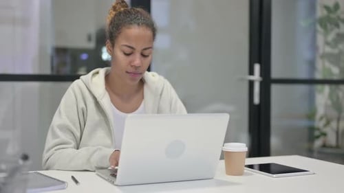 African Woman Working on Laptop in Office
