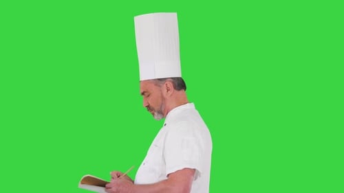 Male Chef Cook Making Notes on a Green Screen Chroma Key
