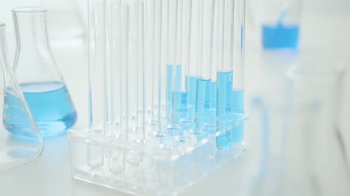 Laboratory Test Tubes and Beakers with Blue Liquid