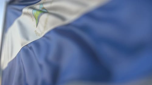 Realistic Waving Nicaragua Flag Loop with Blue Sky Background