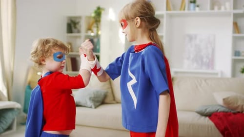 Superhero Children Fist Bump in Living Room