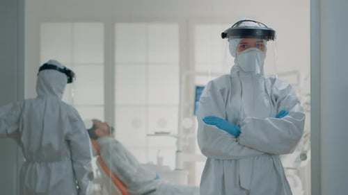 Health Professional in Protective Suit in Medical Office