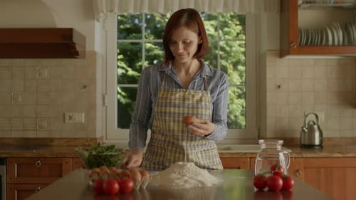 Woman Baking with Flour and Eggs in Kitchen