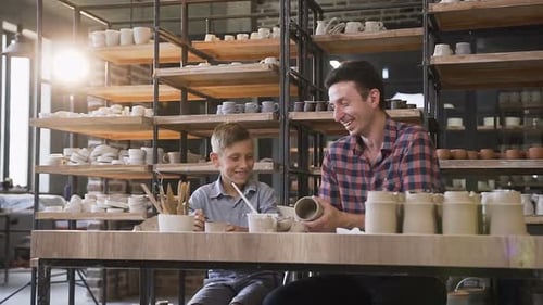Father and Son Creating Ceramics Together in Studio