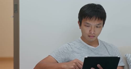 Man Using Tablet Computer at Home