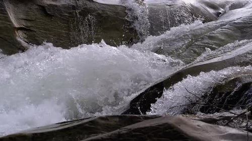 Wild Mountain River Flowing with Stone Boulders and Stone Rapids. Slow Motion
