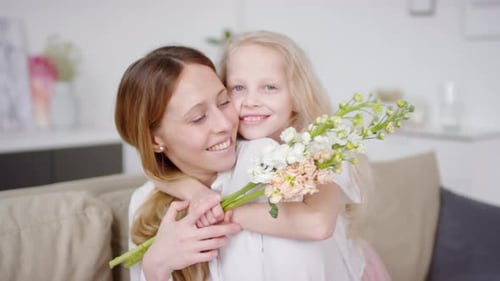 Mother Receives Flowers From Her Happy Child