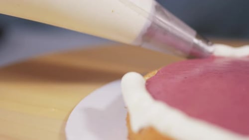 Icing Cake Edge With Pastry Bag Close Up