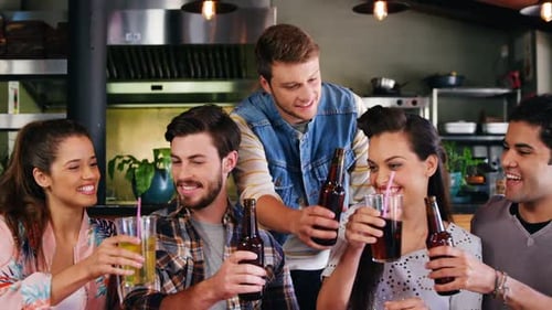 Friends toasting drinks together in restaurant