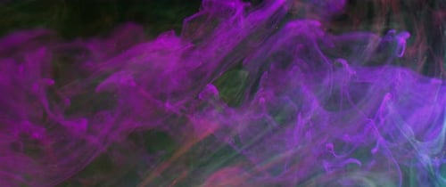 Abstract Plumes of Purple and Teal Ink Swirling