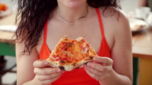 Woman Eating Slice of Pizza Close Up