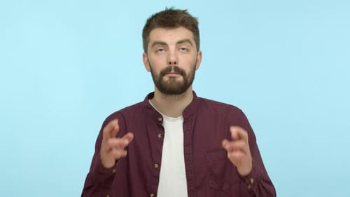 Young Man Crossing Fingers for Good Luck