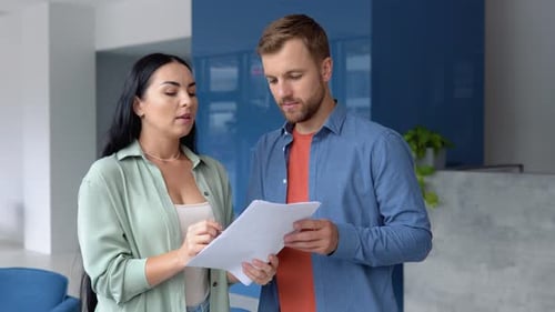 Business Professionals Reviewing Documents and Shaking Hands