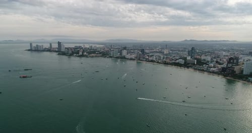 Aerial view of speed boats on the sea near beach city