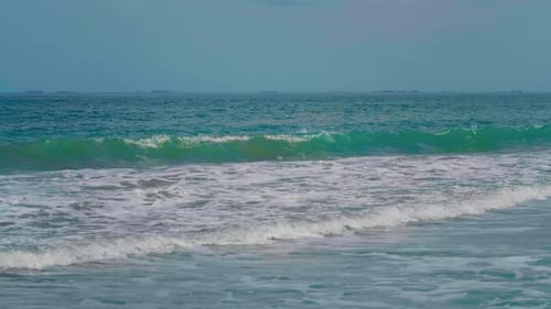 Gentle Ocean Waves Crashing on a Sandy Beach