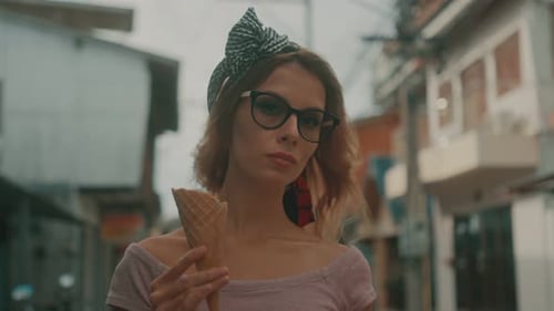 Stylish Woman Holds Ice Cream Cone in City