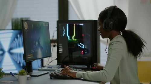 Woman Gaming on Computer at Desk Indoors