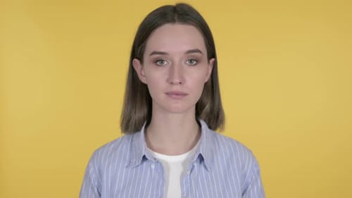 Young Woman Posing in Front of Yellow Background