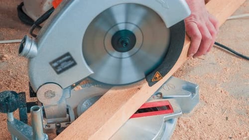 Carpenter Using Circular Saw for Cutting Wooden Boards