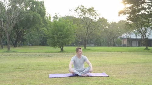 Young Handsome Man Relaxing While Looking Around at the Park