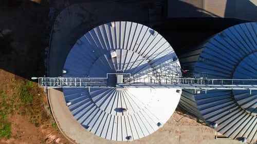 Grain elevator. Metal grain elevator in agricultural zone. Aerial view.