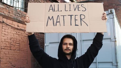 Caucasian Man are Protesting in the Street with Megaphones and Signs