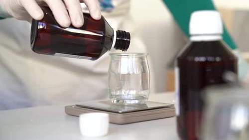 Verser et peser de la glycérine sur un verre à bécher pour créer des pains de savon fabriqués à la main, gros plan